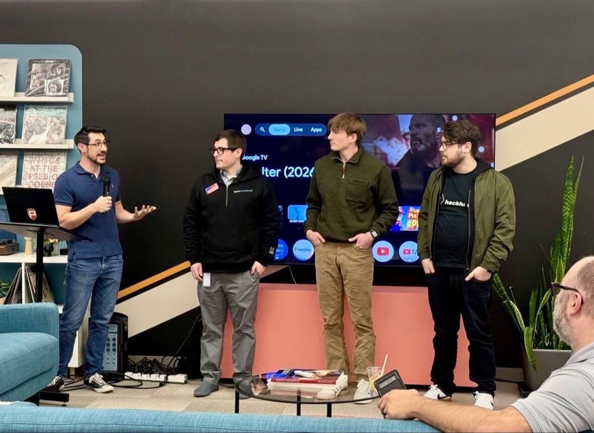 Group of hackathon attendees at a demo presentation